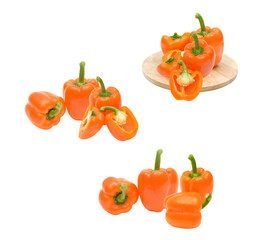 grouping of fresh, vibrant orange bell peppers, whole and cut open, highlighting the crisp texture and brilliant color photograph isolated on black.