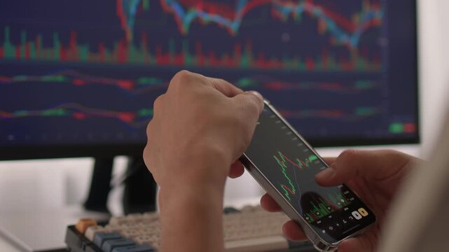 Trader observes price fluctuations closely, Hands manipulate trading charts intensely during session, Trader focuses on chart patterns and volume data to make informed choices