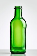 Empty green glass bottle on white studio background, isolated product shot with clean glass and soft reflections