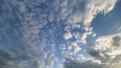 The Depiction of Dramatic Cloud Patterns Against a Beautiful Bright Blue Sky Above Us