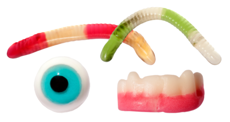spooky novelty gummy candies featuring brightly colored wiggly worms, a blue eyeball, and frightening vampire teeth, isolated against a dark transparent background.