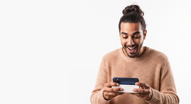 Joyful young man unboxing a new smartphone with an excited expression. Happy male customer holding a mobile phone isolated on a white background with copy space