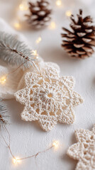 Handmade crocheted snowflake ornament on warm cream background with pinecones and fairy lights in cozy Scandinavian holiday flatlay