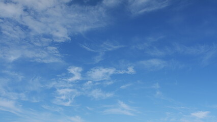 A beautiful blue sky is present with wispy, delicate clouds floating gracefully across it