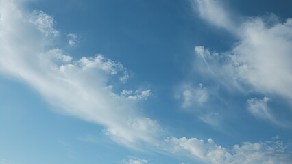 The serene and vibrant sky filled with wispy clouds on a clear and beautiful day