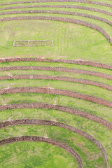 Moray, Cusco, Peru: geometric pattern of ancient Inca terraces used for agricultural experiments. Fine art minimalist photograph emphasizing texture, color and natural design.