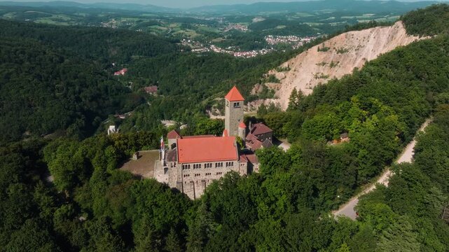 FPV-style drone orbiting around St. Bartholomew Church atop Dilsberg Hill near Heidelberg, Germany, then approaching the tower while circling.