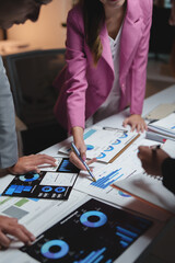 Business team analyzing financial data on charts