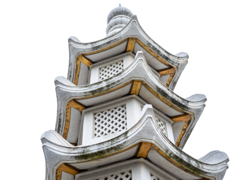 Close up of a detailed multi-tiered white pagoda structure with golden accents and intricate latticework against a stark black background showcasing architectural detail and texture