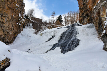 frozen Jermuk waterfall and red rocks of Arpa river canyon (Vayots Dzor, Armenia)