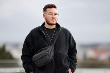 Male plus-size model showcasing smart-casual fashion in urban setting