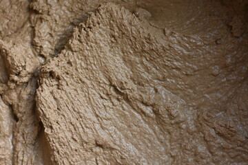 Close-up of moist mixed clay with a clear natural texture of the building material.