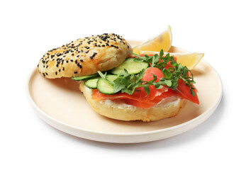 Delicious bagel with salmon, cucumber, arugula and lemon isolated on white