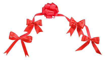 a bright red satin ribbon and decorative bows arranged in a graceful arch or border pattern, isolated as a festive element on black.