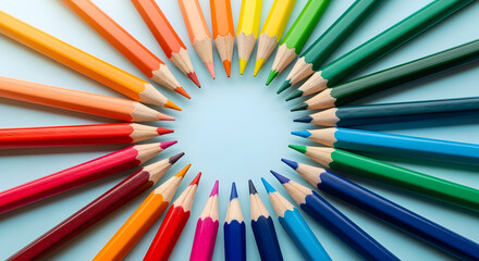Colorful group of wooden color pencils arranged on a blue background suitable for art and school use