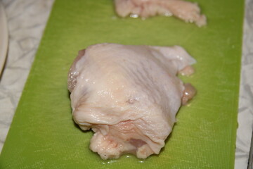a piece of raw chicken on a board,
