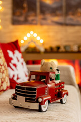 Cute child, blond boy, standing in front of a wooden howse, decorated for christmas, enjoying christmas atmosphere