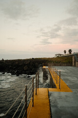 Fototapeta premium Calm ocean scene with ancient railing and mellow clouds