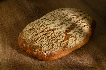 Rustic rye bread on wooden country table