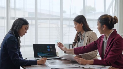 Asian businesswomen collaborating on financial data analysis - Powered by Adobe