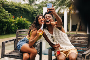 Friends take selfie outdoors by poolside