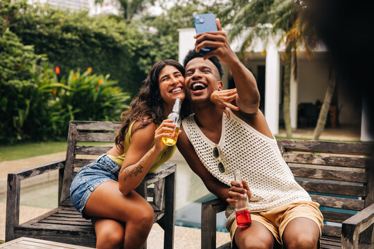 Friends take selfie outdoors by poolside