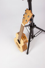 A ukulele stands at the counter. a musical concert. learning music and playing an instrument. an isolated object. close-up.