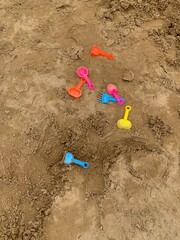 colorful of plastic toy on sand beach background