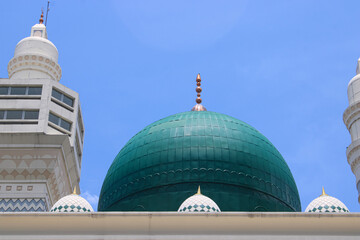 Iconic Green Dome Flanked by Mosque Minarets