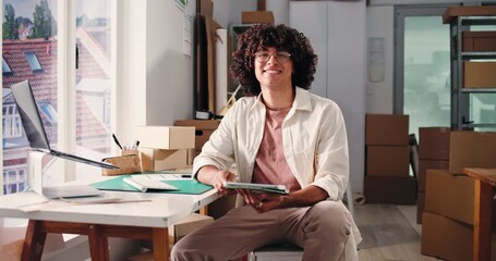 Face, logistics and tablet with happy man in office for delivery, distribution or shipping of boxes. App, schedule and smile of employee in supply chain depot for agenda, package tracking or planning