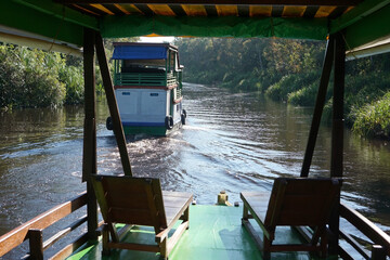 The klotok houseboat is a traditional wooden boat complete with a bed, kitchen and bathroom for cruising along the Sekonyer River, Tanjung Puting National Park, Kalimantan, Indonesia. © jovinko