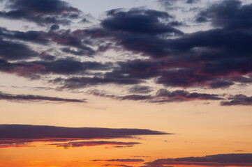 Dramatic sunset sky with dark clouds and vibrant orange and yellow hues