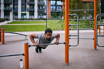 Fototapeta premium Determined Man Exercises Outdoors to Lose Weight and Build Health Through Outdoor Workout