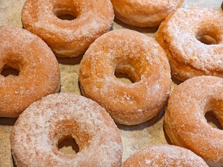 close-up group of ring-shaped donuts coated with sugar