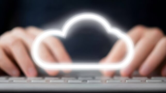 Professional working on computer actively inputting data using keyboard symbolizing cloud technology and digital information storage.