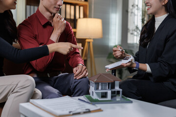 Couple discussing home buying investment with real estate agent