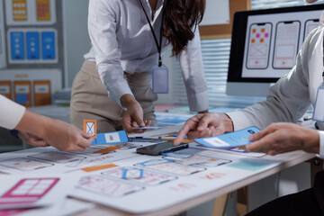 Ux ui designers collaborating on mobile app development