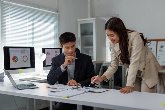 Business colleagues analyzing financial data charts in office - Powered by Adobe