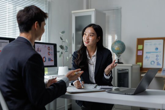 Business professionals discussing strategy in modern office setting