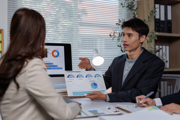 Businessman presenting market analysis data during office meeting