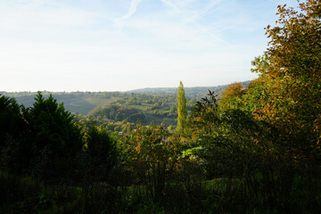Scenic Autumn Landscape Of Rolling Green And Gold Hills With Distant Quarry Under A Bright Sky, Seen From Black Rocks, Cromford, Derbyshire.