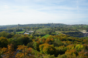 Panoramic View Of An Autumn Valley With Vibrant Trees, Green Fields, A Small Village, And A Quarry In Black Rocks, Cromford, Derbyshire