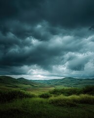 Dramatic Storm Clouds Loom Over Verdant Rolling Hills Under a Moody Sky.