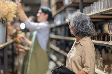 Mother and Family Business Owner Teaching About Material Production and Recycling