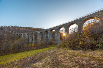 Kristofovo Udoli Railway Viaduct Surrounded by Colorful Autumn Trees at Sunrise with Warm Morning Light Shining Through the Valley Near Liberec in Northern Czech Republic Scenic Landscape Architecture
