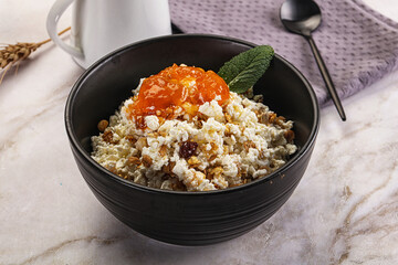 Curd with granola and orange jam