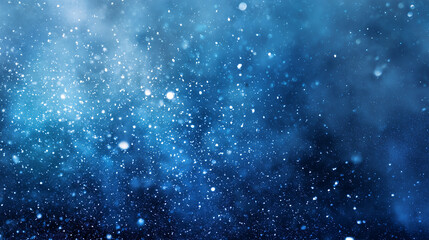 Blue background with tiny specks of dust/snow in suspension. Christmas