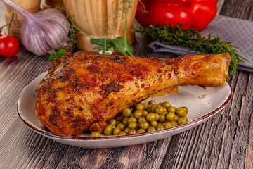 Baked turkey drumstick served green peas