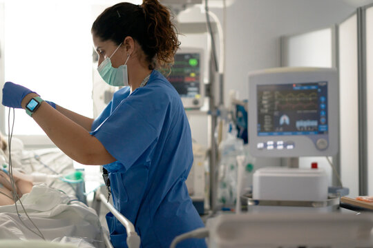 Nurse preparing medical equipment in intensive care unit - Powered by Adobe