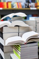 stack of books, close up. Open book on the table in library. Back to school concept. Open book on table with blur bookshelf background